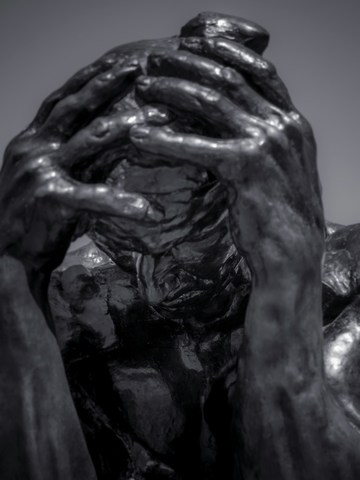 sculpture of anxious and tired man with hands holding head