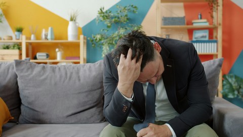 An executive dealing with professional exhaustion