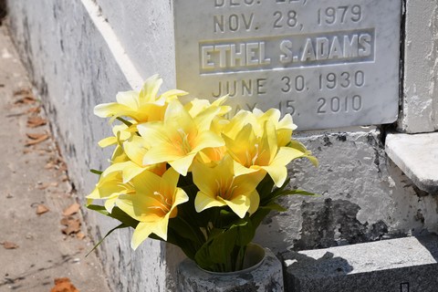 Headstone with flower in memory of partner