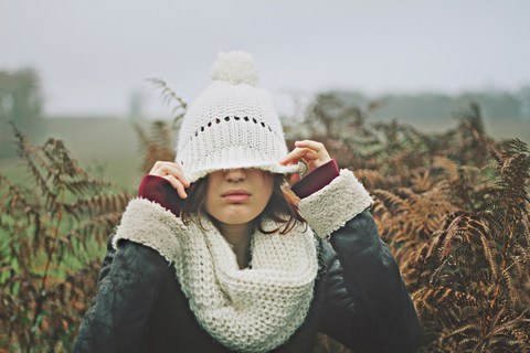 Frustrated and exhausted woman pulling hat down